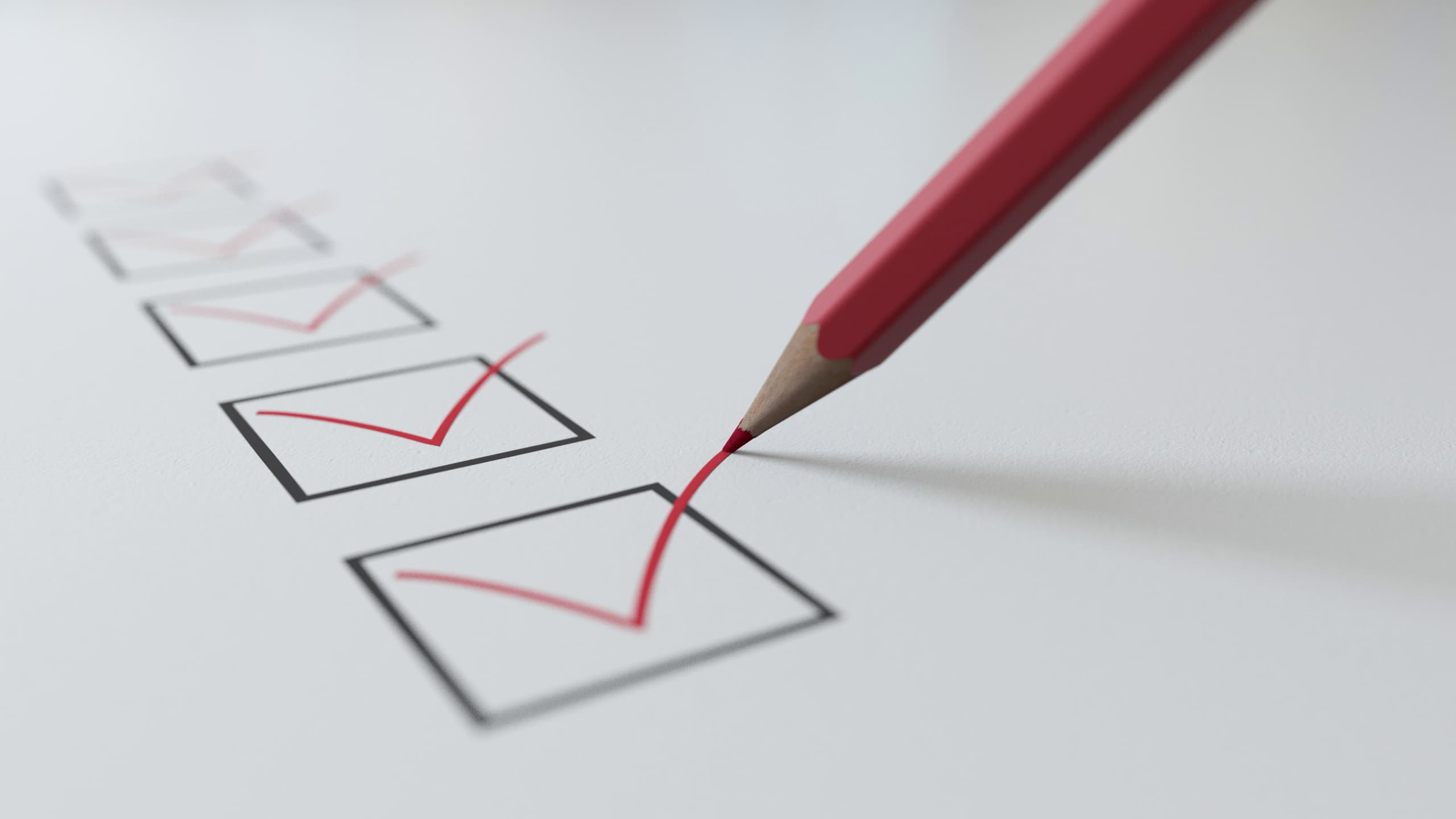 Checklist with a red pencil ticking boxes